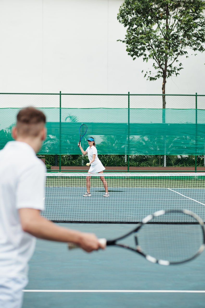 Tennis players rallying on an outdoor court